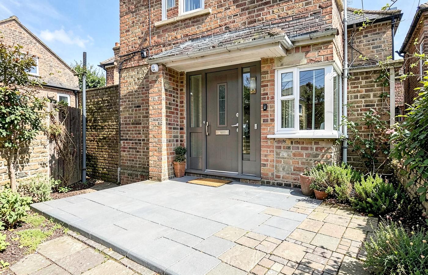 Level access entrance with new door and paving after the work